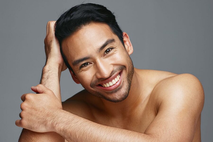 man smiling after his male rhinoplasty in NYC